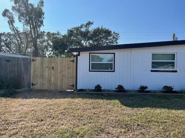 view of side of property with a lawn