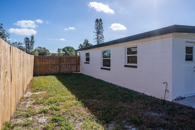 view of side of property with a yard