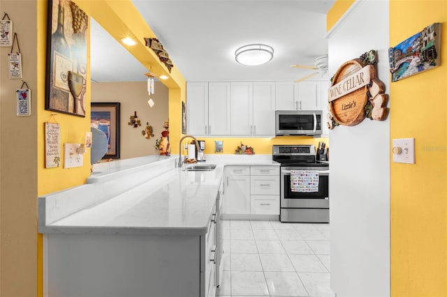 kitchen featuring white cabinets, kitchen peninsula, and appliances with stainless steel finishes