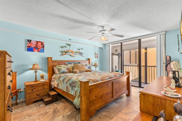 bedroom featuring a textured ceiling, access to outside, and ceiling fan