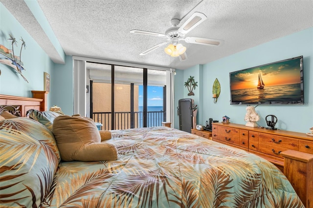 bedroom featuring access to exterior, ceiling fan, floor to ceiling windows, and a textured ceiling