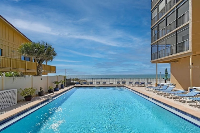 view of swimming pool with a water view