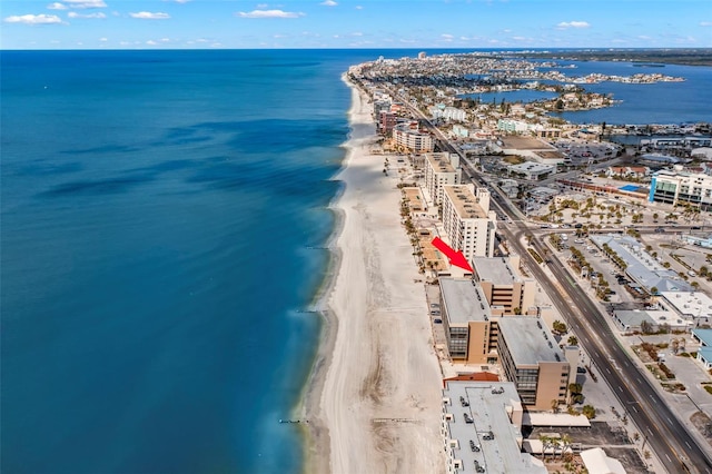 bird's eye view with a water view and a beach view