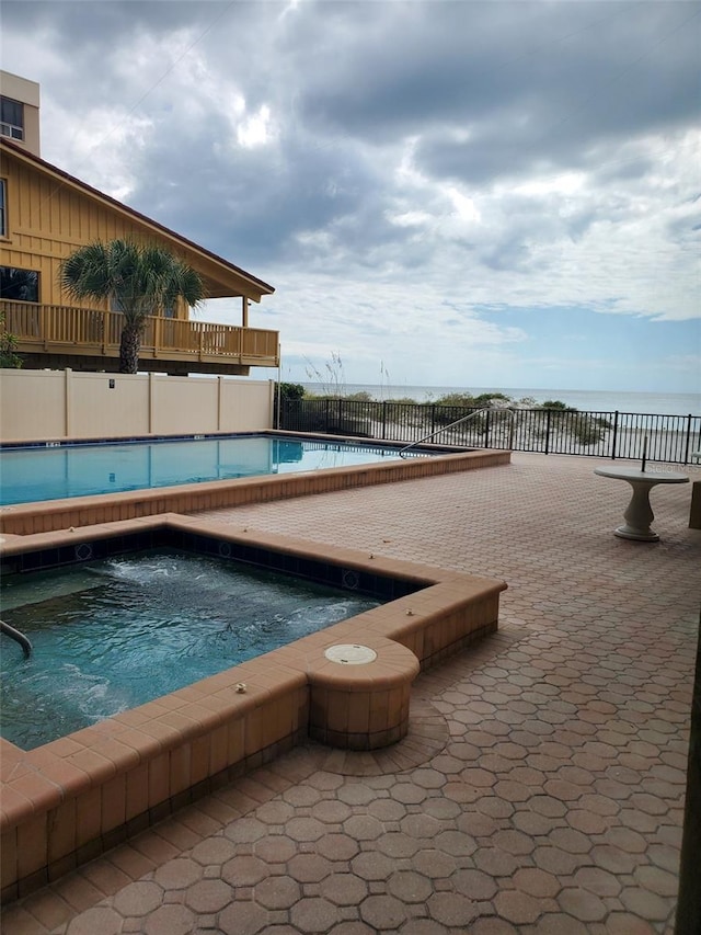 view of pool featuring a hot tub and a patio area