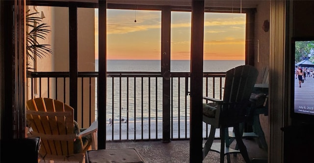 sunroom with a view of the beach and a water view