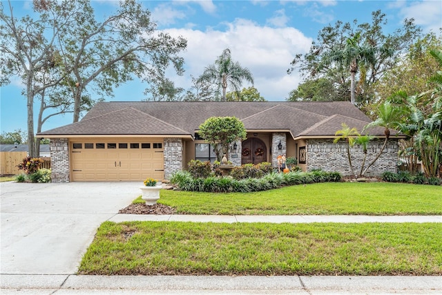 ranch-style home featuring a front lawn and a garage