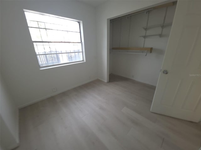 3102 W Leroy St Unit A, Tampa, FL 33607 - unfurnished bedroom with a closet and light wood-style floors