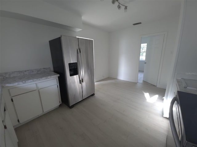 3102 W Leroy St Unit A, Tampa, FL 33607 - kitchen featuring stainless steel refrigerator with ice dispenser, light wood-style flooring, and white cabinets