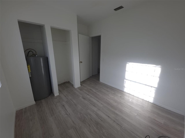 3102 W Leroy St Unit A, Tampa, FL 33607 - unfurnished bedroom featuring water heater and light wood-style floors
