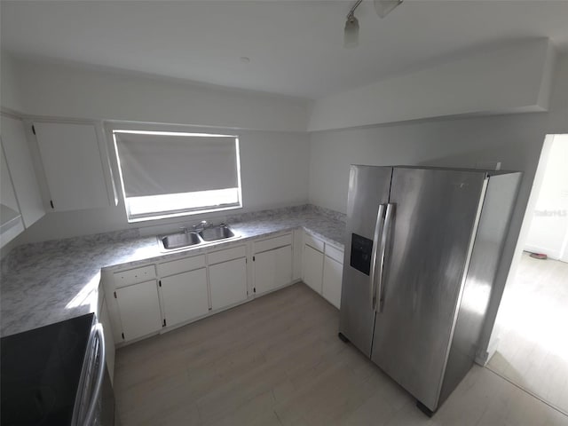 3102 W Leroy St Unit A, Tampa, FL 33607 - kitchen with stainless steel fridge with ice dispenser, light countertops, white cabinetry, range, and light wood finished floors