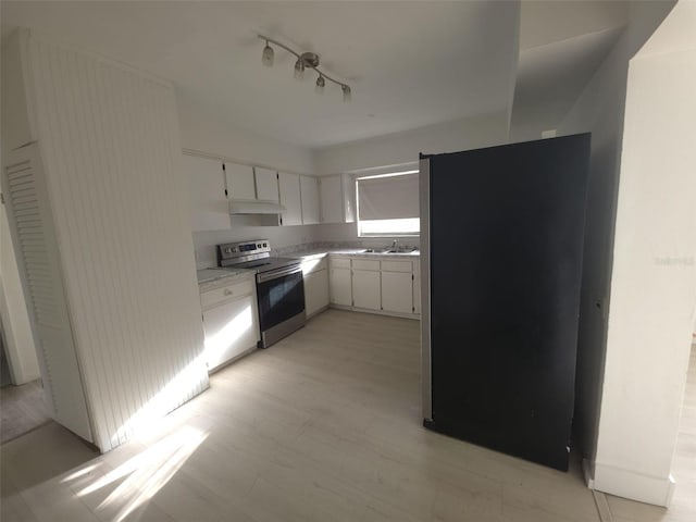 3102 W Leroy St Unit A, Tampa, FL 33607 - kitchen with appliances with stainless steel finishes, light countertops, white cabinets, under cabinet range hood, and light floors