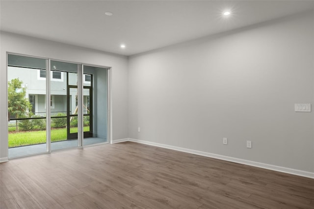 empty room featuring dark hardwood / wood-style floors and plenty of natural light