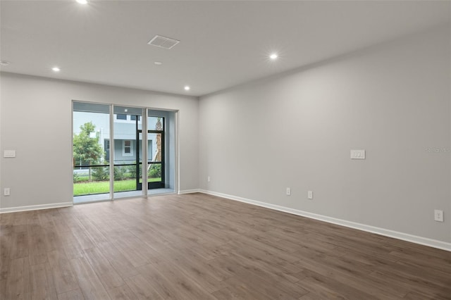 unfurnished room featuring hardwood / wood-style flooring