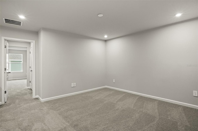 unfurnished room featuring light colored carpet