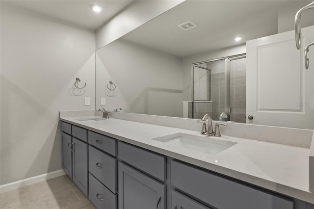 bathroom featuring vanity, walk in shower, and tile patterned floors