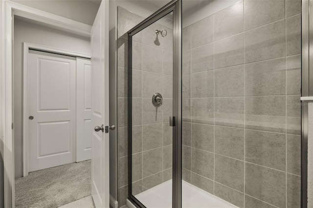 bathroom featuring a shower with shower door