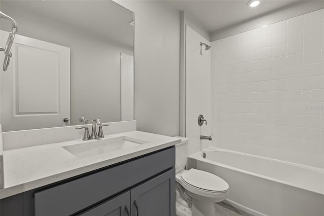 full bathroom with toilet, tiled shower / bath combo, and vanity