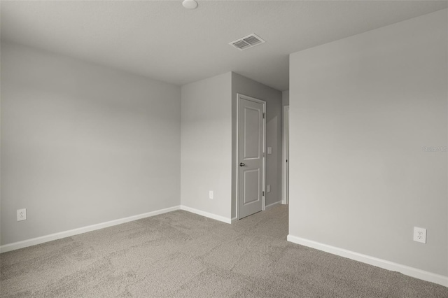 spare room with light colored carpet