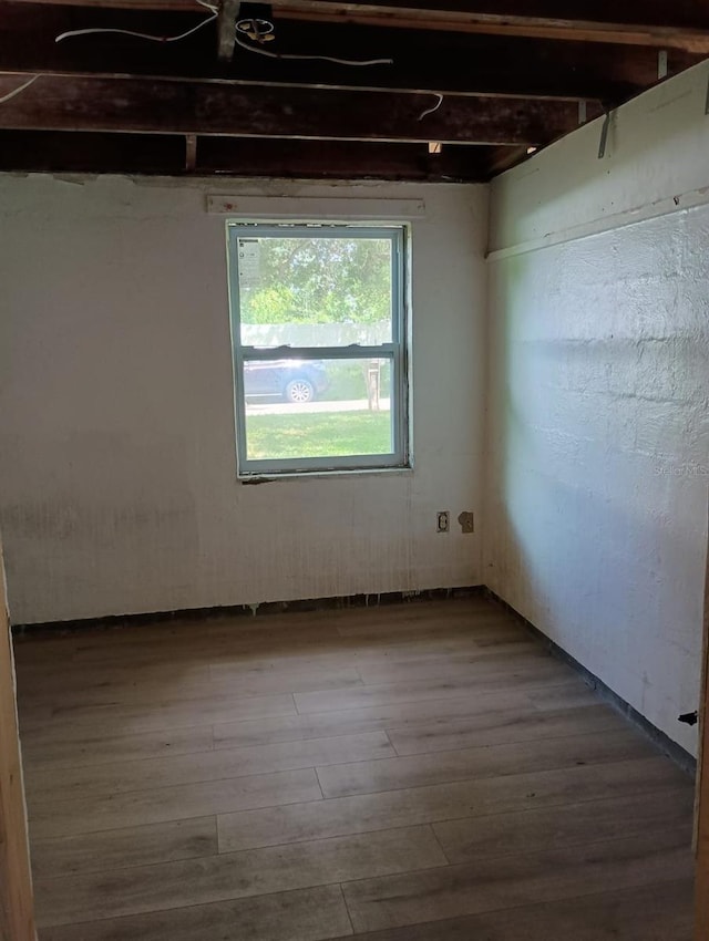 unfurnished room with hardwood / wood-style floors