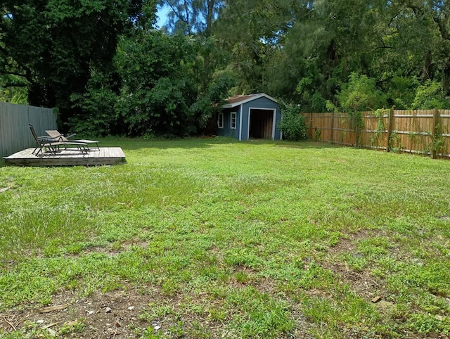 view of yard featuring a storage unit and a wooden deck