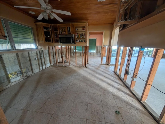 empty room with ceiling fan and wooden ceiling