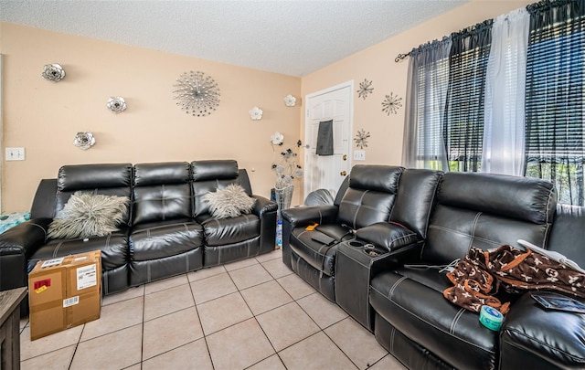 living room featuring a textured ceiling and light tile patterned floors