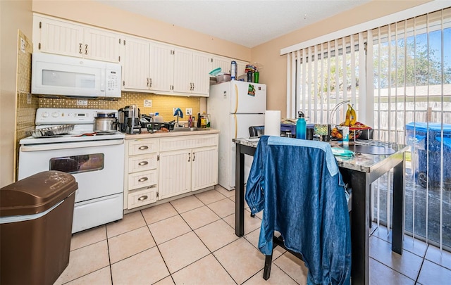 kitchen featuring white appliances, light tile patterned flooring, tasteful backsplash, and sink