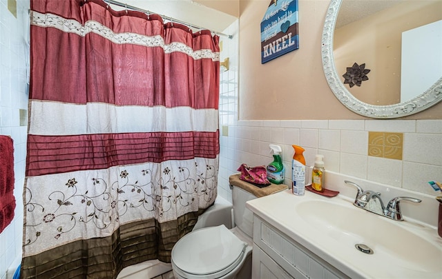 full bathroom with vanity, toilet, tile walls, and shower / bath combo