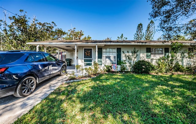 ranch-style home featuring a front yard and a carport