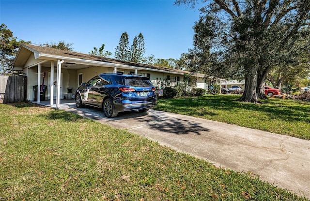 view of front of property with a carport and a front yard