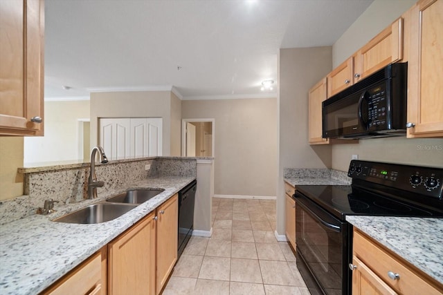 kitchen featuring light brown cabinetry, sink, light stone counters, and black appliances