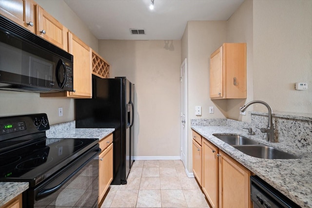 kitchen featuring light stone countertops, sink, black appliances, and light brown cabinets