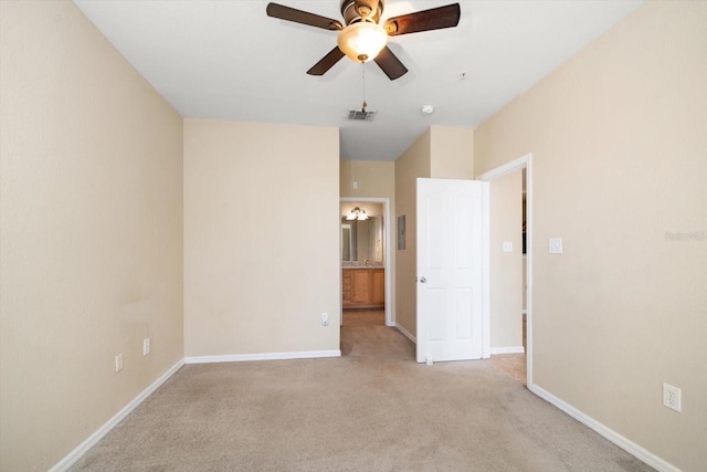 carpeted empty room featuring ceiling fan