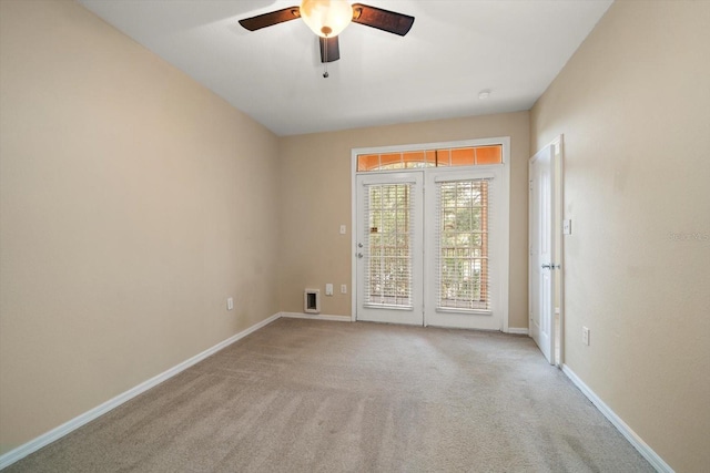 carpeted empty room featuring ceiling fan