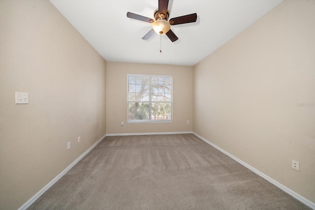 carpeted empty room featuring ceiling fan