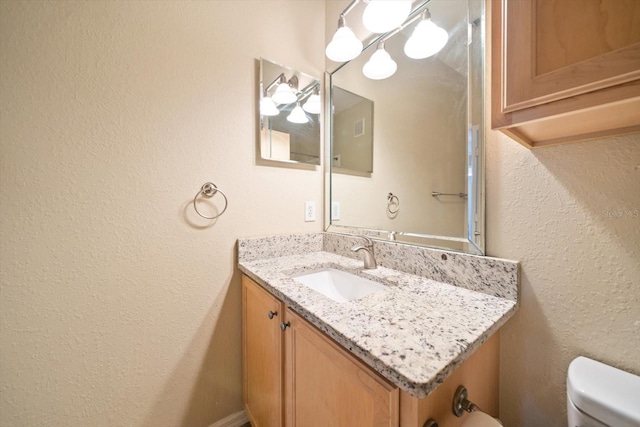 bathroom with vanity and toilet