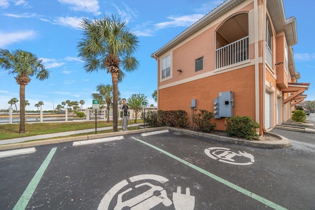 5000 Culbreath Key Way Unit 1-203, Tampa, FL 33611 - view of building exterior featuring uncovered parking and a water view
