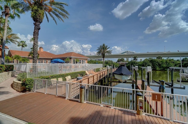 wooden terrace featuring a water view and a boat dock