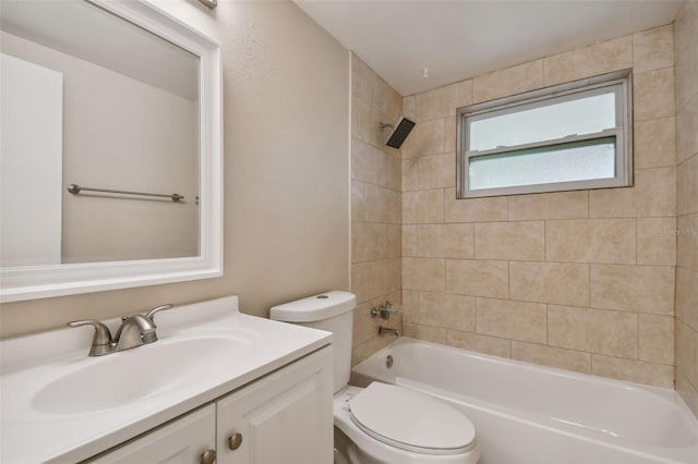 full bathroom featuring vanity, tiled shower / bath combo, and toilet