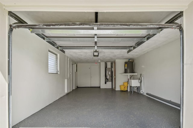 garage featuring sink, water heater, and a garage door opener