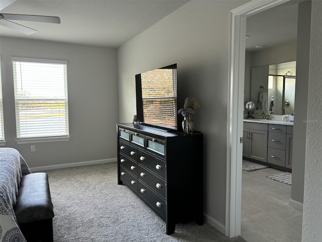 carpeted bedroom featuring connected bathroom and ceiling fan