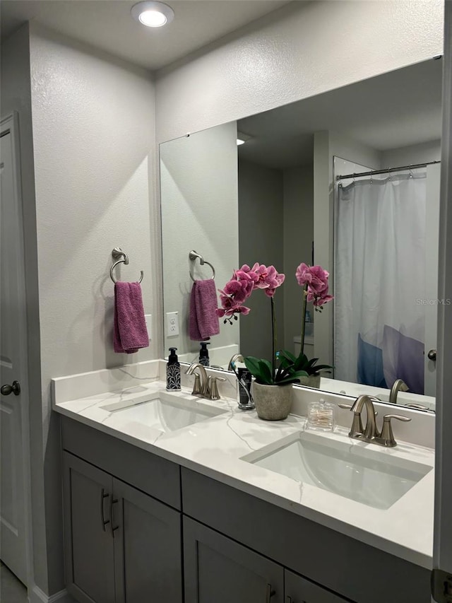 bathroom with vanity and a shower with shower curtain