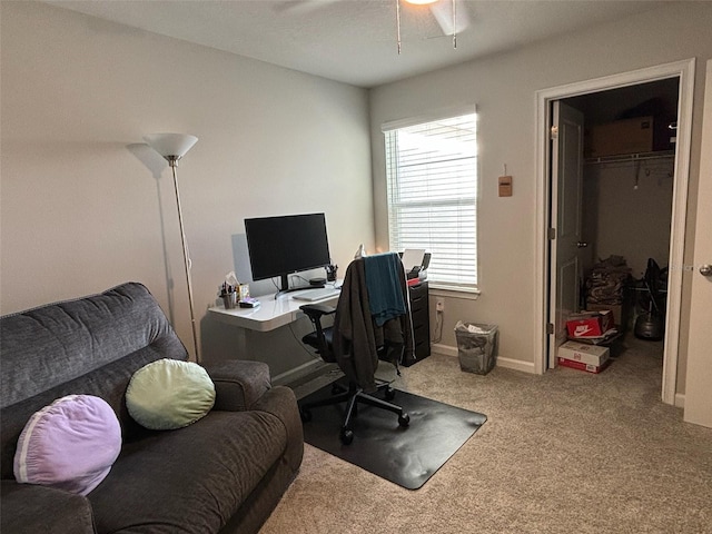 carpeted office space with ceiling fan