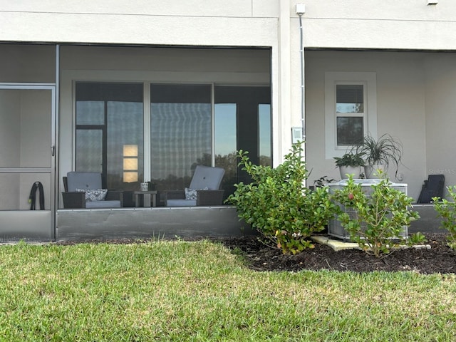 exterior space featuring an outdoor living space, central AC, and a lawn