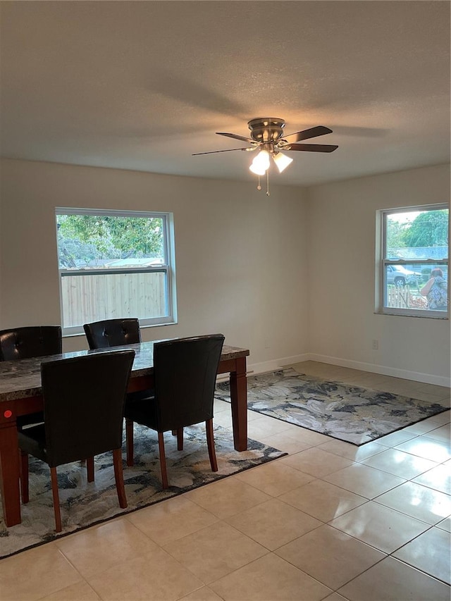 tiled dining area featuring ceiling fan