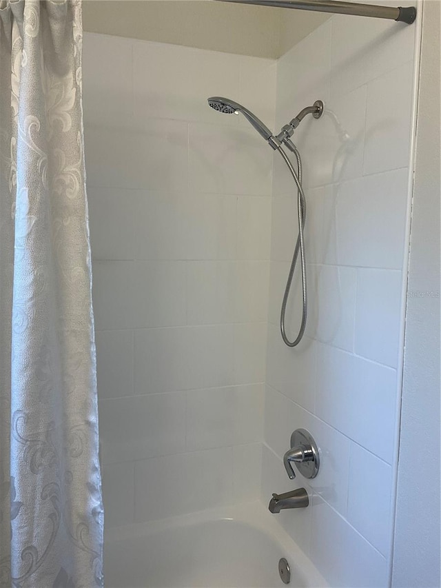 bathroom featuring shower / tub combo with curtain