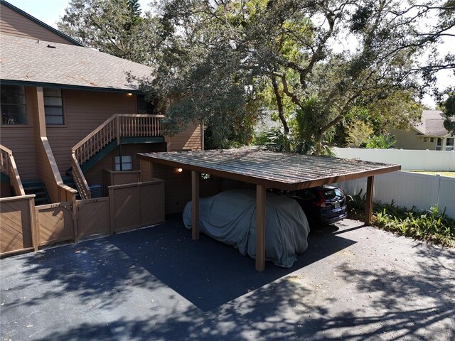 1106 Lennox Rd W, W, Palm Harbor, FL 34683 - view of patio featuring driveway, fence, and a carport