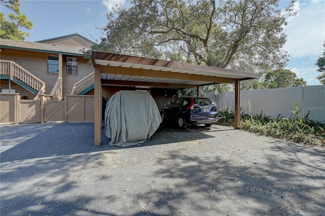 view of parking / parking lot featuring a carport