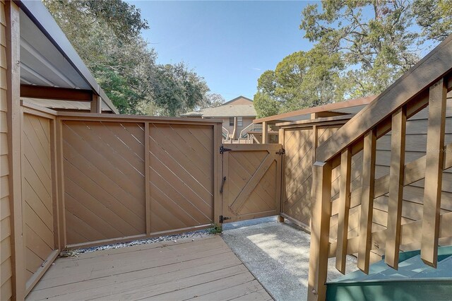 view of gate with a wooden deck