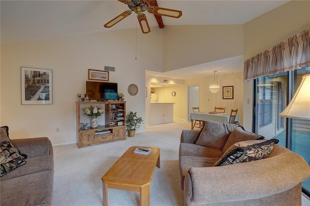 living room featuring ceiling fan, high vaulted ceiling, and light colored carpet